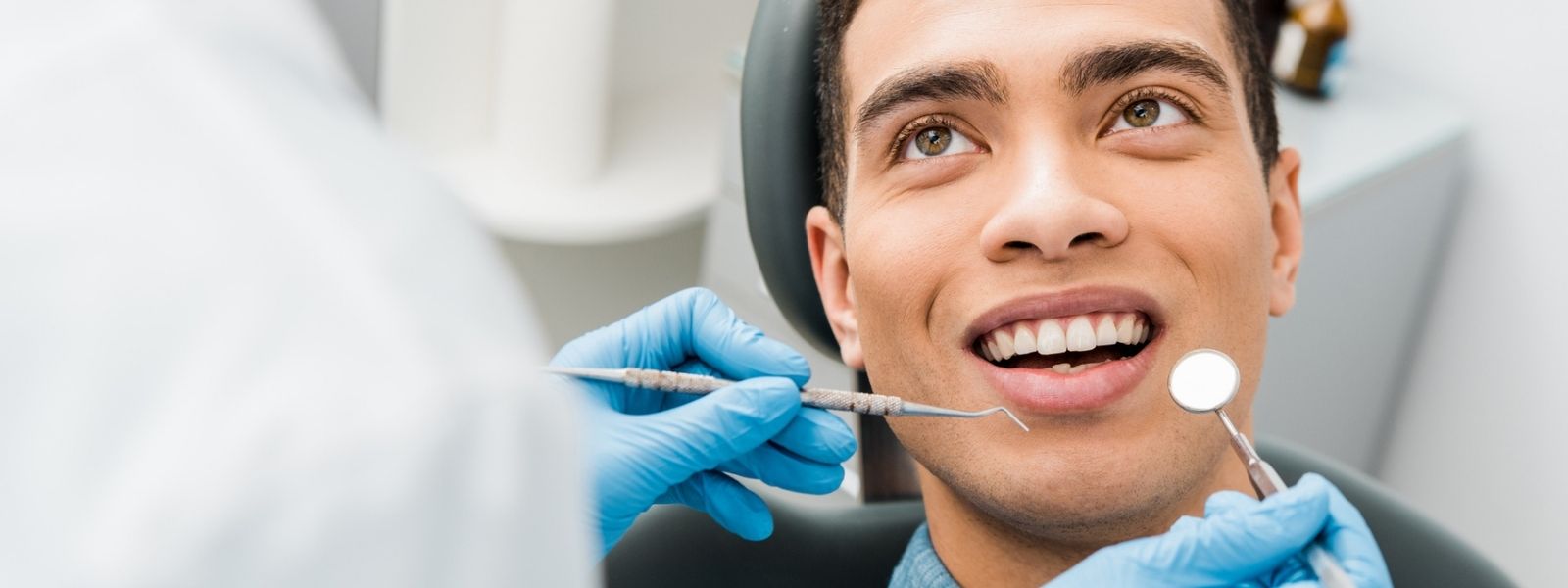 Dark skinned man doing dental checkup