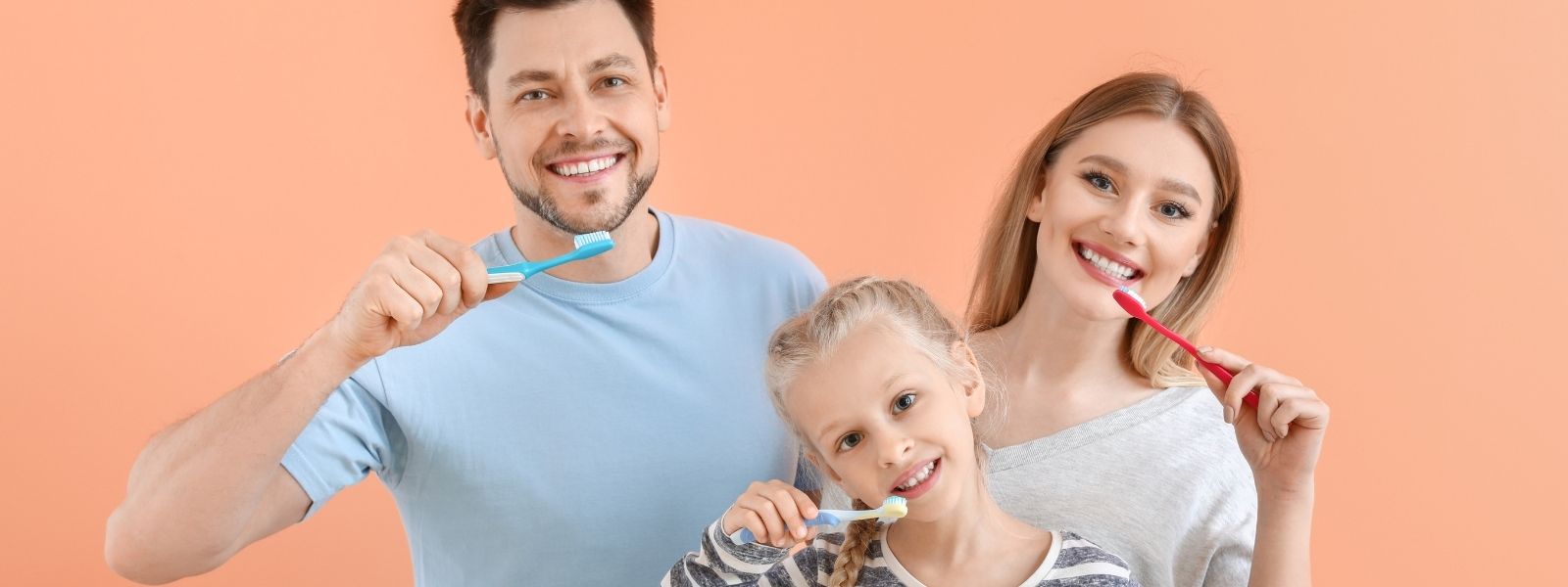 Happy family brushing teeth